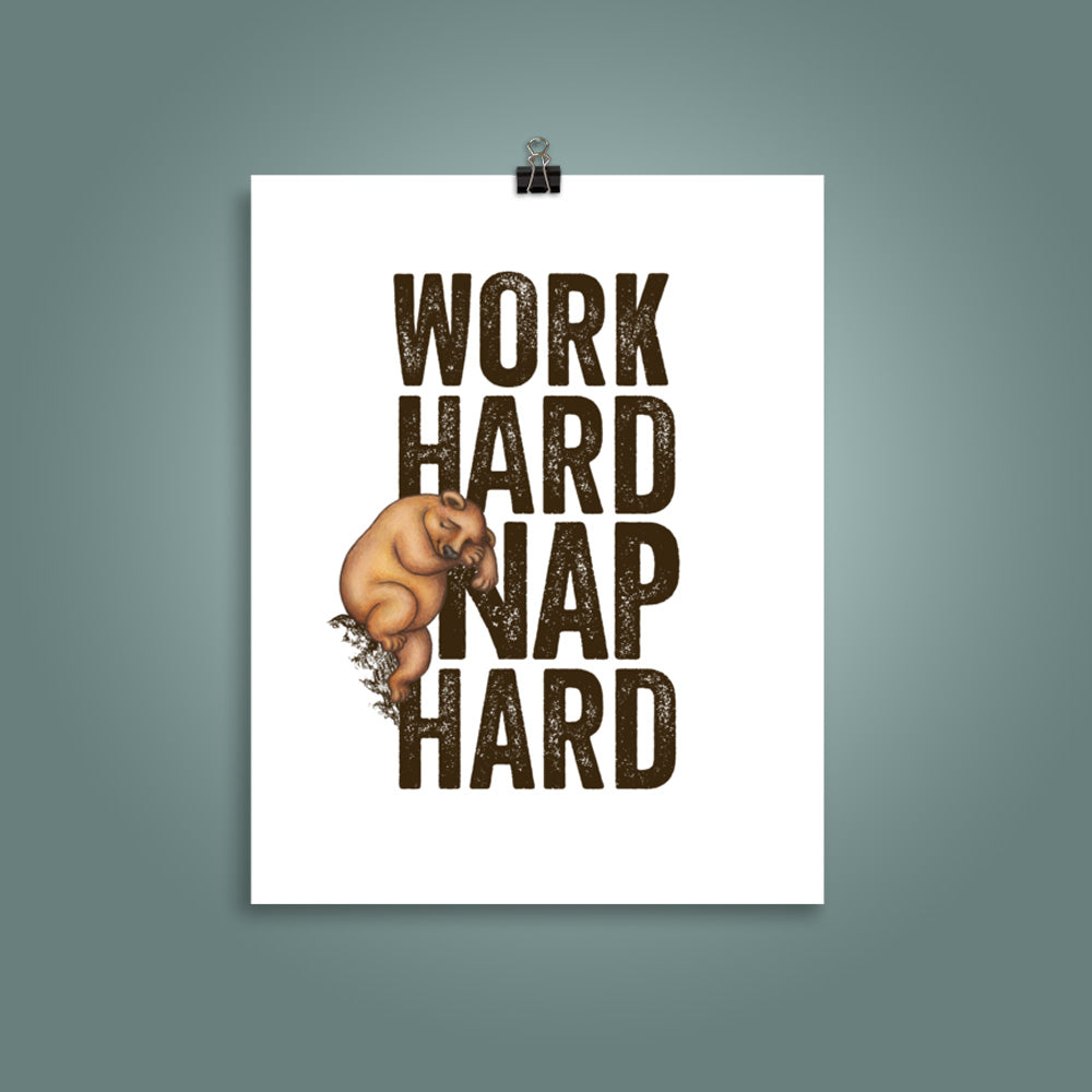 11 inch by 14 inch poster with bold, upper case 'Work Hard Nap Hard' text and a cute illustration of a sleepy bear on a plain white surface, with a teal wall behind the poster