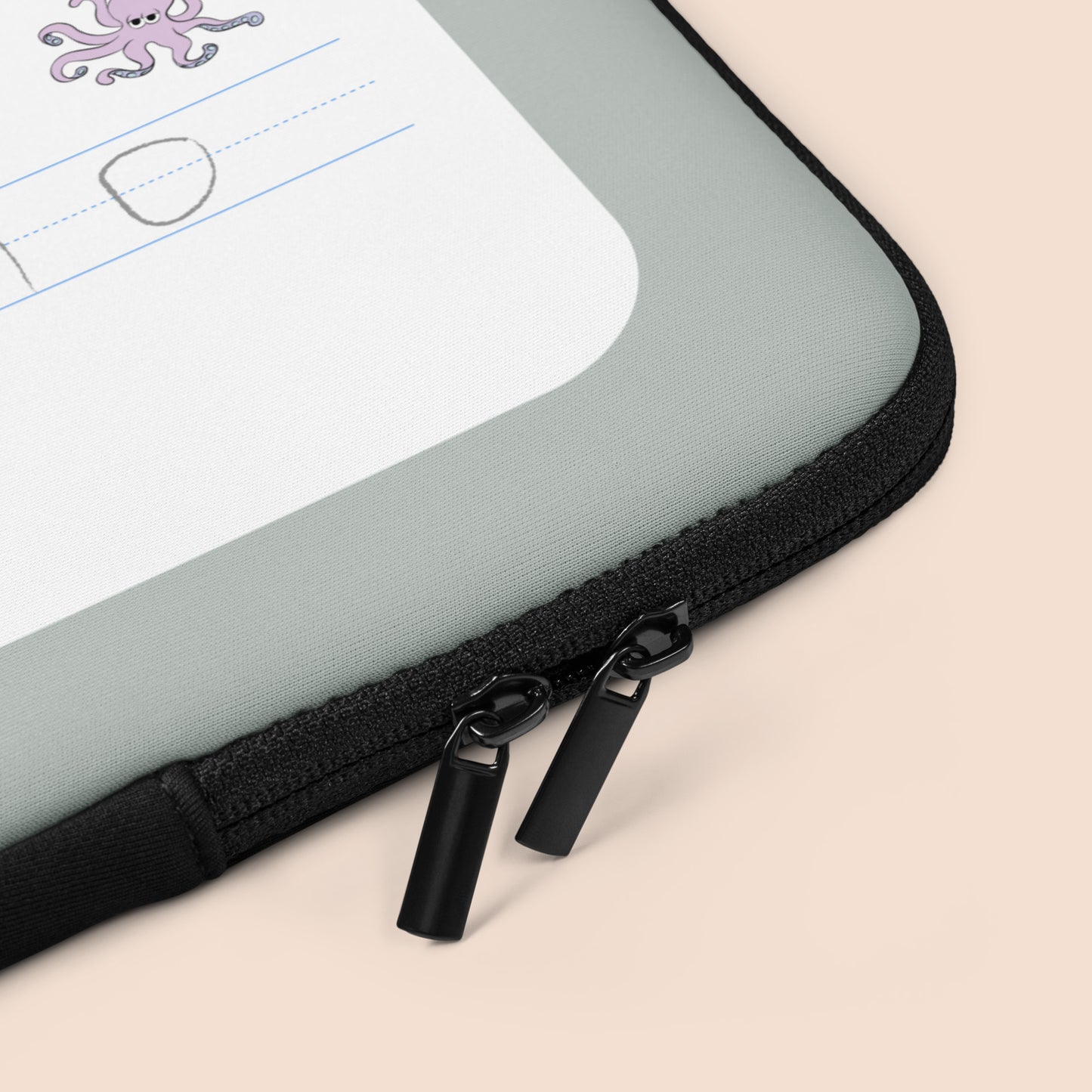 Corner of a gray and white laptop case with black zippers on a peachy beige surface