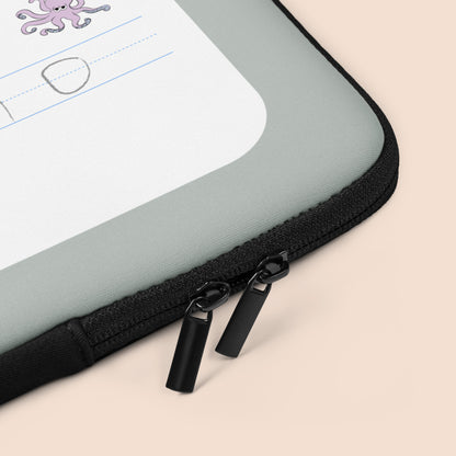 Corner of a gray and white laptop case with black zippers on a peachy beige surface