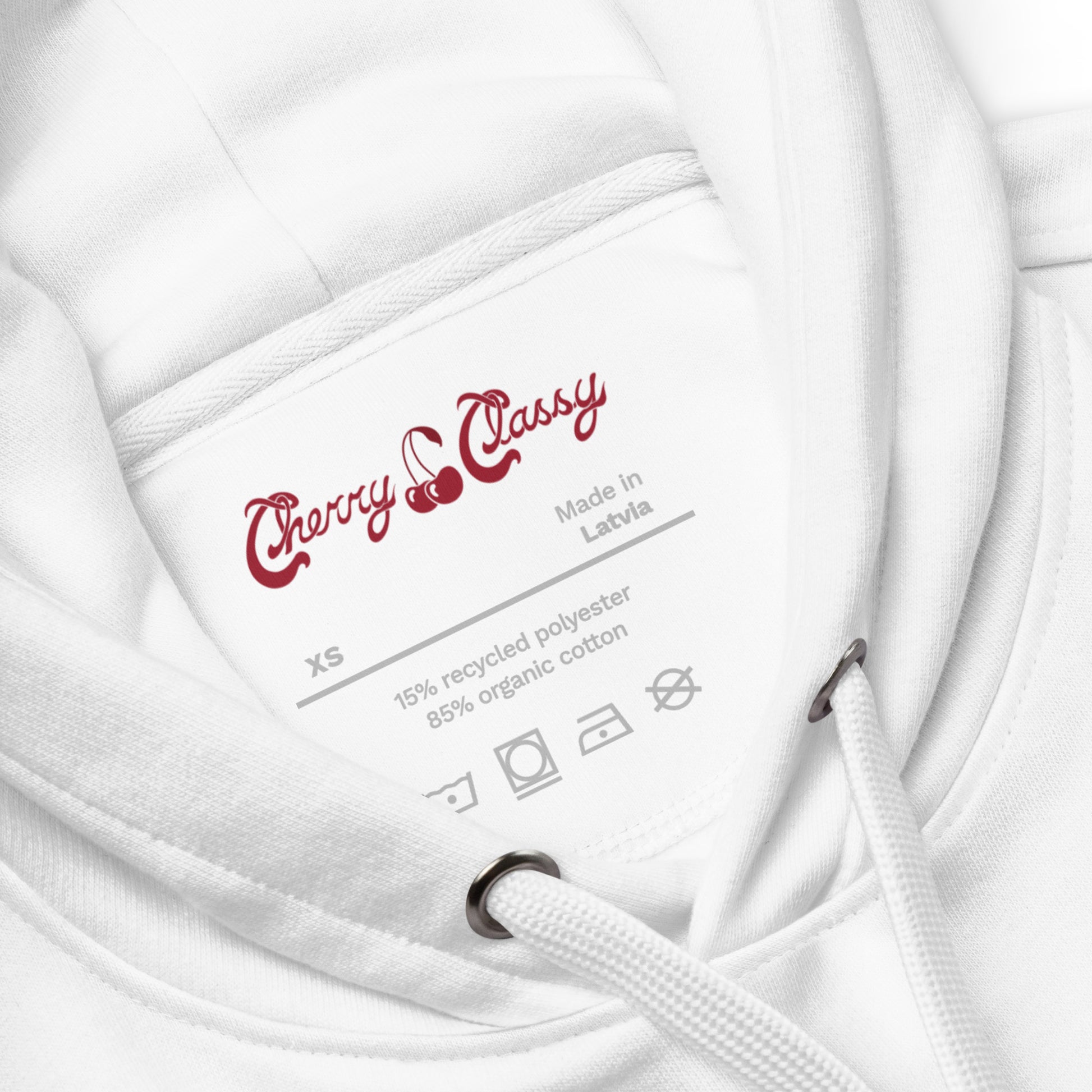 Close-up of a white hoodie with Cherry Classy label and fabric content details.