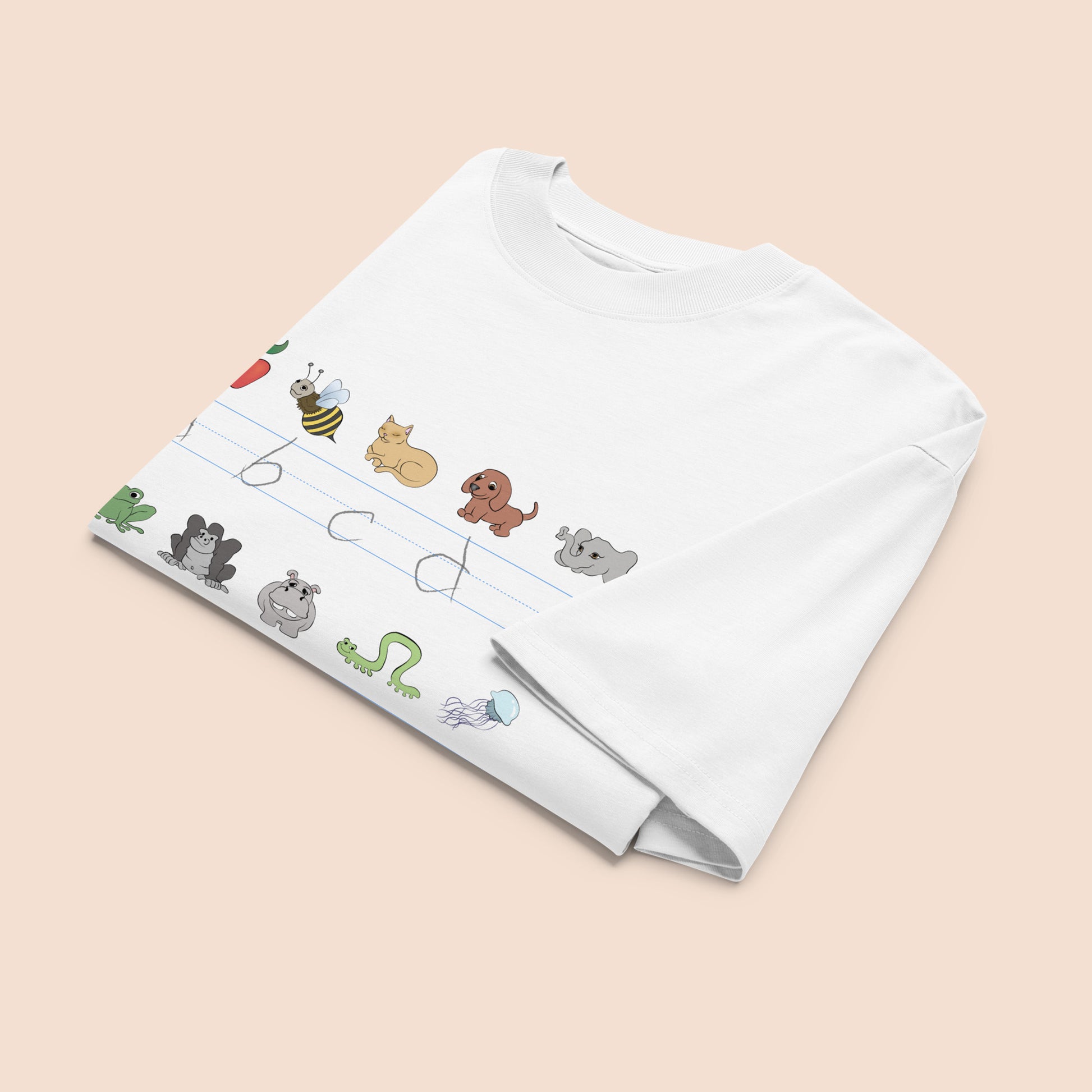White t-shirt with cartoon animal illustrations and part of an alphabet on a peachy beige background