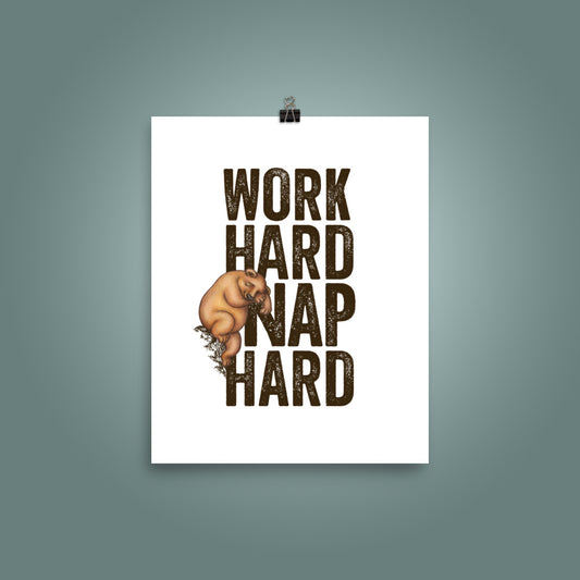 8 inch by 10 inch poster with bold, upper case 'Work Hard Nap Hard' text and a cute  illustration of a sleepy bear on a plain white surface, with a teal wall behind the poster
