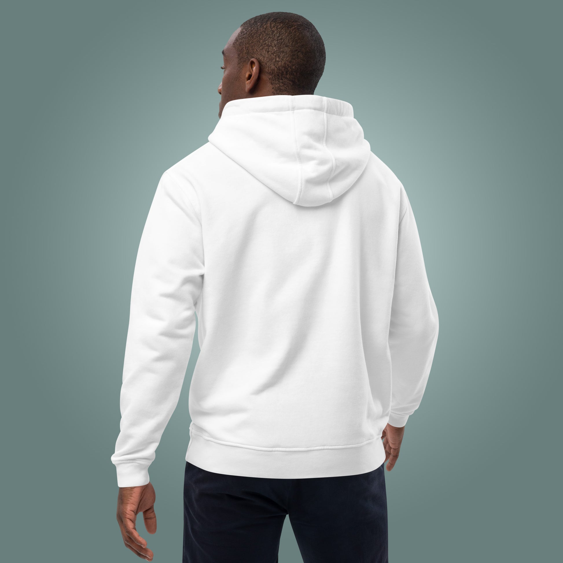 The back view of a man wearing a white hoodie on a grey background